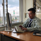 Tan Shun Wai works at his desk in Soja’s City Hall.